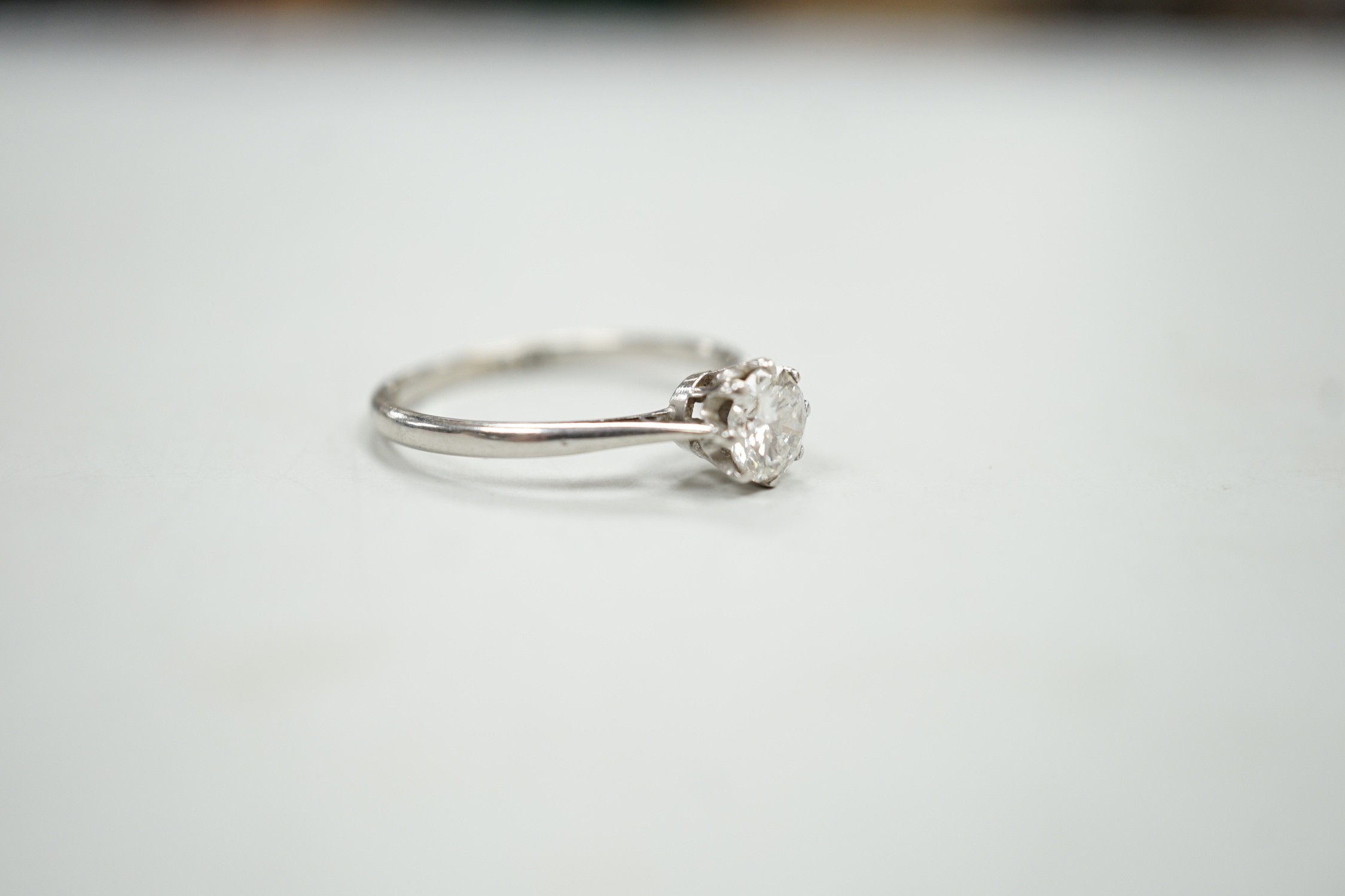 A white metal (stamped plat) and solitaire diamond ring, size P, gross weight 2.9 grams